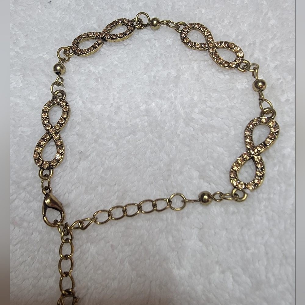 Gold-Tone Rhinestone Infinity Sign Adjustable Bracelet.